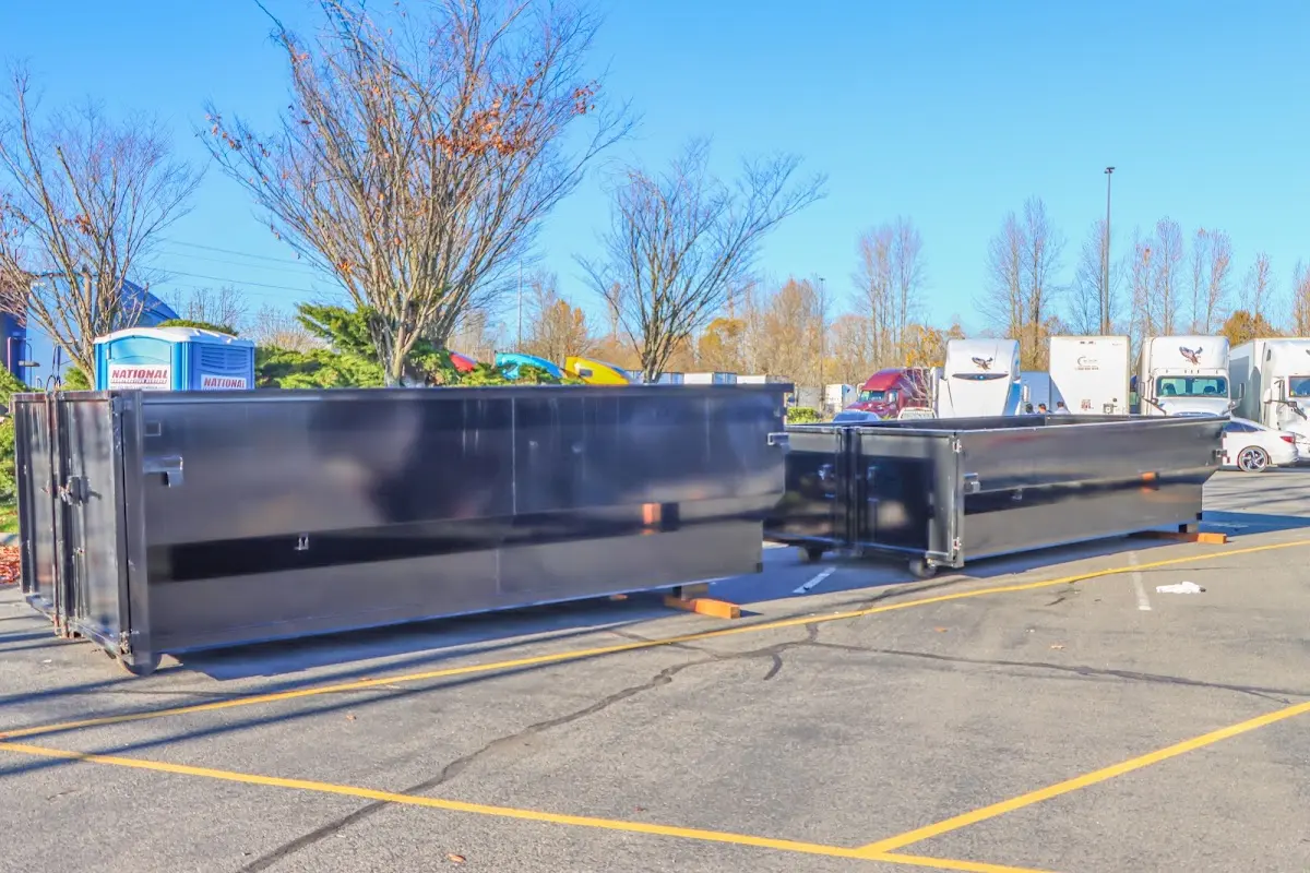 Professional dumpster rental service with roll-off container on residential driveway in West Melbourne